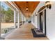 Inviting front porch featuring wood flooring, a stained wood ceiling, and elegant light fixtures at 203 Shelby Ln, Fayetteville, GA 30215