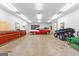 Spacious garage featuring a classic car, ATV, and work area for the ultimate hobbyist at 203 Shelby Ln, Fayetteville, GA 30215