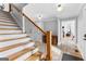 Hallway with wood staircase, tiled floors, and an open view to other living spaces at 203 Shelby Ln, Fayetteville, GA 30215