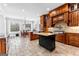 Open kitchen with island, natural light, wooden cabinets, granite counters, and stainless steel appliances at 203 Shelby Ln, Fayetteville, GA 30215