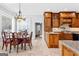 Open kitchen to dining with granite counters, wood cabinets and island at 203 Shelby Ln, Fayetteville, GA 30215