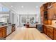 Open kitchen with island, natural light, wooden cabinets, granite counters, and stainless steel appliances at 203 Shelby Ln, Fayetteville, GA 30215