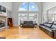 Living room with stone fireplace, large windows, and leather seating for relaxing or entertaining at 203 Shelby Ln, Fayetteville, GA 30215