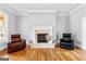 Bright living room featuring a fireplace and two leather chairs at 203 Shelby Ln, Fayetteville, GA 30215