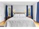 Spacious main bedroom with a decorative comforter, bedside tables, and natural light at 203 Shelby Ln, Fayetteville, GA 30215