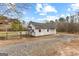 Detached white outbuilding with garage and pool views, set in a private outdoor space at 203 Shelby Ln, Fayetteville, GA 30215