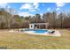 Sparkling in-ground pool with a spacious sundeck and adjacent pool house, ideal for entertaining and enjoying the outdoors at 203 Shelby Ln, Fayetteville, GA 30215
