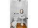 Classic powder room featuring a pedestal sink, chandelier, and neutral wall color at 203 Shelby Ln, Fayetteville, GA 30215