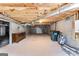 Spacious unfinished basement offering ample potential with exposed ceiling and concrete walls at 203 Shelby Ln, Fayetteville, GA 30215