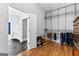 Walk-in closet with an open door to a bathroom, custom shelves, hardwood floors, and a wooden dresser at 203 Shelby Ln, Fayetteville, GA 30215