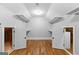 A walk-in closet with wood floors, open storage, and two attic access doors, providing space and functionality at 203 Shelby Ln, Fayetteville, GA 30215