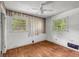 Bedroom with hardwood floors, two windows, and decorative wallpaper at 2531 Hood Nw Ave, Atlanta, GA 30318