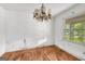 A bedroom with hardwood floors and a decorative chandelier at 2531 Hood Nw Ave, Atlanta, GA 30318