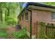 Brick home exterior, featuring a fenced yard and wooded landscape at 2531 Hood Nw Ave, Atlanta, GA 30318