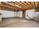 Unfinished basement with exposed ceiling, brick chimney, and concrete floor offers potential for customization at 5552 Smithfield Rd, Bowdon, GA 30108