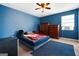 Blue bedroom with a comfortable bed, natural light, and ample closet space at 5552 Smithfield Rd, Bowdon, GA 30108
