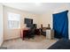 Bedroom featuring natural light, a desk setup, and neutral carpet at 5552 Smithfield Rd, Bowdon, GA 30108