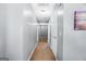 Clean, bright hallway with neutral paint, carpet flooring, and white doors leading to various rooms at 5552 Smithfield Rd, Bowdon, GA 30108