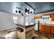 Functional kitchen featuring an island with storage, white appliances, wood cabinets, and natural light at 5552 Smithfield Rd, Bowdon, GA 30108