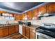 Galley kitchen boasting stainless steel appliances, wood cabinets, and laminate countertops at 5552 Smithfield Rd, Bowdon, GA 30108