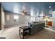 Inviting living room featuring a comfy sofa and views of the open kitchen and dining area at 5552 Smithfield Rd, Bowdon, GA 30108