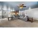 Open-concept living room showcasing a comfortable sectional sofa, and access to the kitchen at 5552 Smithfield Rd, Bowdon, GA 30108