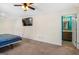 Bright main bedroom with ensuite bath featuring plush carpet and neutral paint at 5552 Smithfield Rd, Bowdon, GA 30108