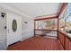 Charming front porch with a wooden deck, white siding, and a glimpse of the snowy front yard at 5552 Smithfield Rd, Bowdon, GA 30108