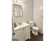 This powder room features a white vanity, neutral walls, and vinyl flooring at 1448 Pine Log Ne Rd # C, Conyers, GA 30012