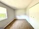 Neutral-toned bedroom with a large closet, neutral carpet, and window views at 1448 Pine Log Ne Rd # C, Conyers, GA 30012