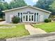 Low shot of the clubhouse showing the front entryway, number, and landscaping at 1448 Pine Log Ne Rd # C, Conyers, GA 30012