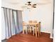 Bright dining room features a ceiling fan, hardwood floors, and natural light from the window with gray curtains at 1448 Pine Log Ne Rd # C, Conyers, GA 30012