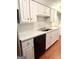 Kitchen featuring white cabinetry, dark appliances and light-colored countertops at 1448 Pine Log Ne Rd # C, Conyers, GA 30012