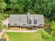 Aerial view of a charming home with lush landscaping, a welcoming walkway, and a well-maintained lawn at 45 Plantation Ln, Locust Grove, GA 30248