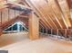 Spacious unfinished attic features plywood flooring and beams, ready for customization or additional storage at 45 Plantation Ln, Locust Grove, GA 30248
