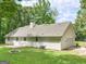 Backyard features a lush lawn, patio, fire pit, and exterior of the home at 45 Plantation Ln, Locust Grove, GA 30248