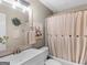 Bathroom featuring a shower-tub combo, vanity, and tastefully selected artwork at 45 Plantation Ln, Locust Grove, GA 30248