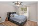 Bright bedroom featuring wood laminate flooring, natural light, and comfortable queen bed at 45 Plantation Ln, Locust Grove, GA 30248