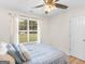 A sunlit bedroom featuring a bed with blue pattern and a large window at 45 Plantation Ln, Locust Grove, GA 30248