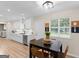 Bright dining area with wood floors and plenty of natural light from the window at 45 Plantation Ln, Locust Grove, GA 30248