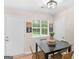 The dining area has a dark table and wicker chairs, with a window for natural light at 45 Plantation Ln, Locust Grove, GA 30248