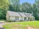Lovely single Gathering home with a well kept lawn, green foliage, and unique olive-green front door at 45 Plantation Ln, Locust Grove, GA 30248