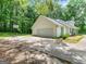 Charming home featuring a two-car garage, long driveway with basketball hoop, and mature landscaping at 45 Plantation Ln, Locust Grove, GA 30248
