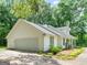 Charming home featuring a two-car garage, and mature landscaping at 45 Plantation Ln, Locust Grove, GA 30248