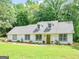 Inviting home featuring lush greenery, manicured front yard, and appealing architecture, enhancing curb appeal at 45 Plantation Ln, Locust Grove, GA 30248