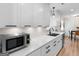 Bright kitchen showcasing white cabinetry, sleek countertops, and stainless steel microwave at 45 Plantation Ln, Locust Grove, GA 30248