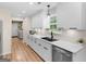 The newly remodeled kitchen boasts white cabinetry and modern stainless-steel appliances at 45 Plantation Ln, Locust Grove, GA 30248
