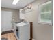 Functional laundry room with washer, dryer, and ample natural light from the window at 45 Plantation Ln, Locust Grove, GA 30248