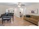 Comfortable living room features a piano, couch, and office area for versatile living at 45 Plantation Ln, Locust Grove, GA 30248