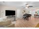 Open-concept living room with a TV, piano, and view to the kitchen and dining area at 45 Plantation Ln, Locust Grove, GA 30248